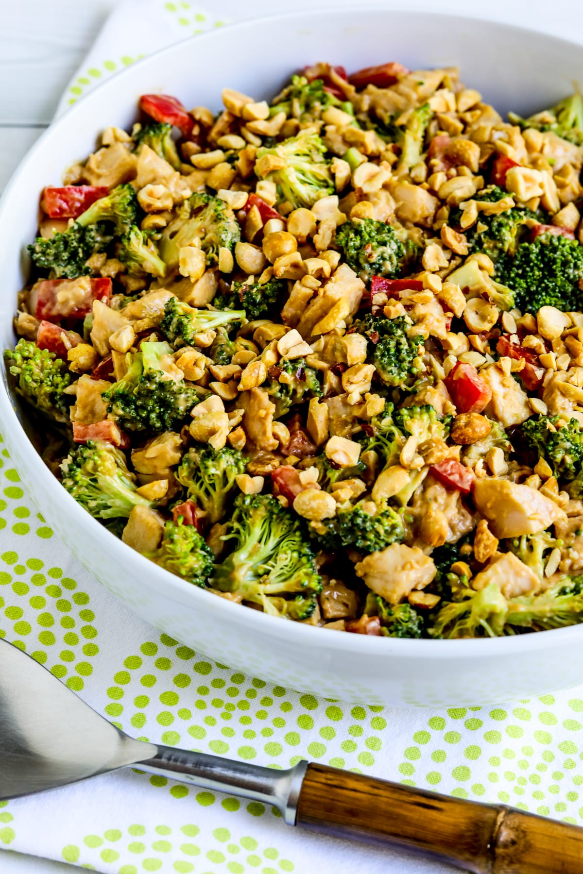 Chicken Broccoli Salad shown in serving bowl with spoon.