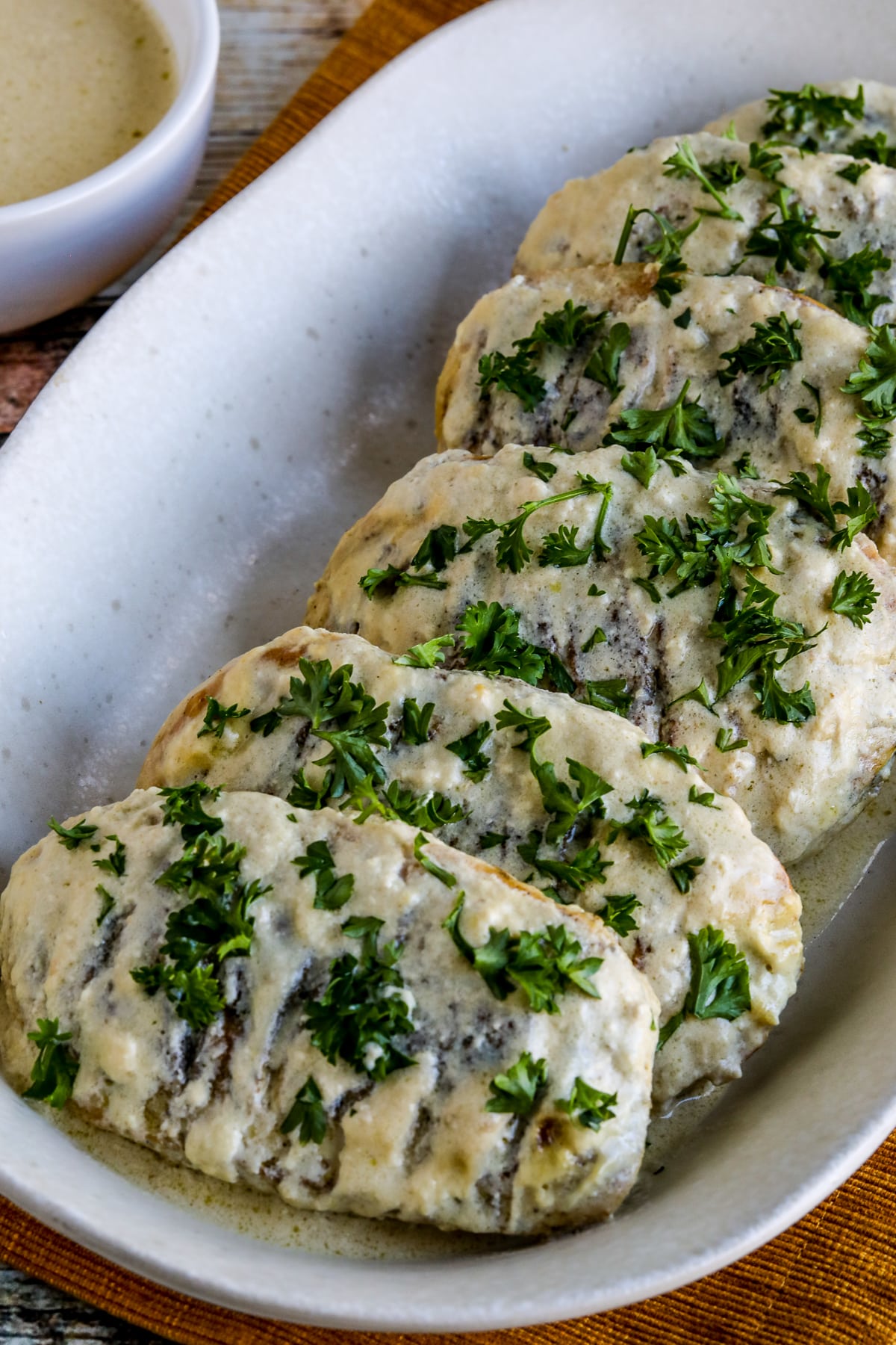 Janet's Easy Mustard Chicken shown on serving platter with parsley garnish.