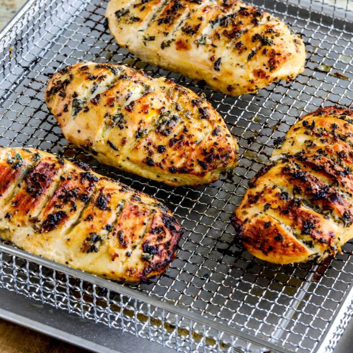 Air Fryer Marinated Chicken Breasts shown in Air Fryer basket