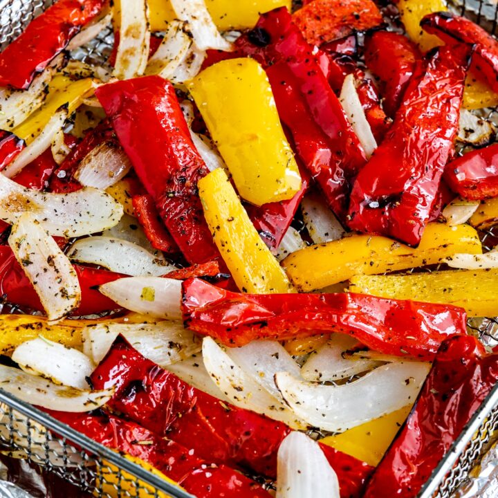 Air Fryer Peppers and Onions close up photo of cooked peppers and onions in air fryer basket