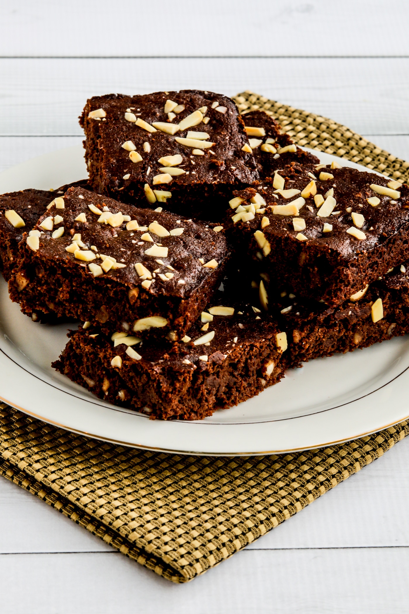 Almond Flour Brownies shown stacked on serving plate