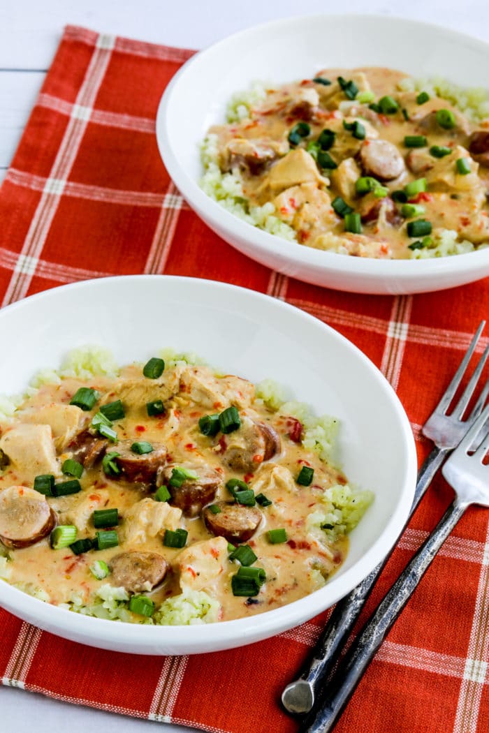 Chicken and Sausage Stew shown in two serving bowls and served over cauliflower rice