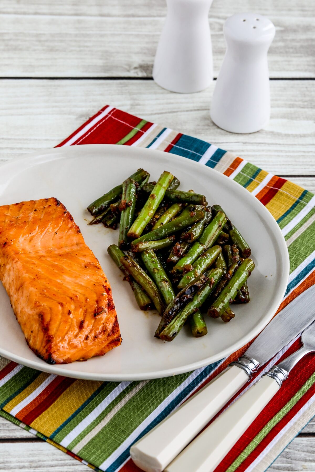 Maple Glazed Salmon on serving plate with silverware and napkin