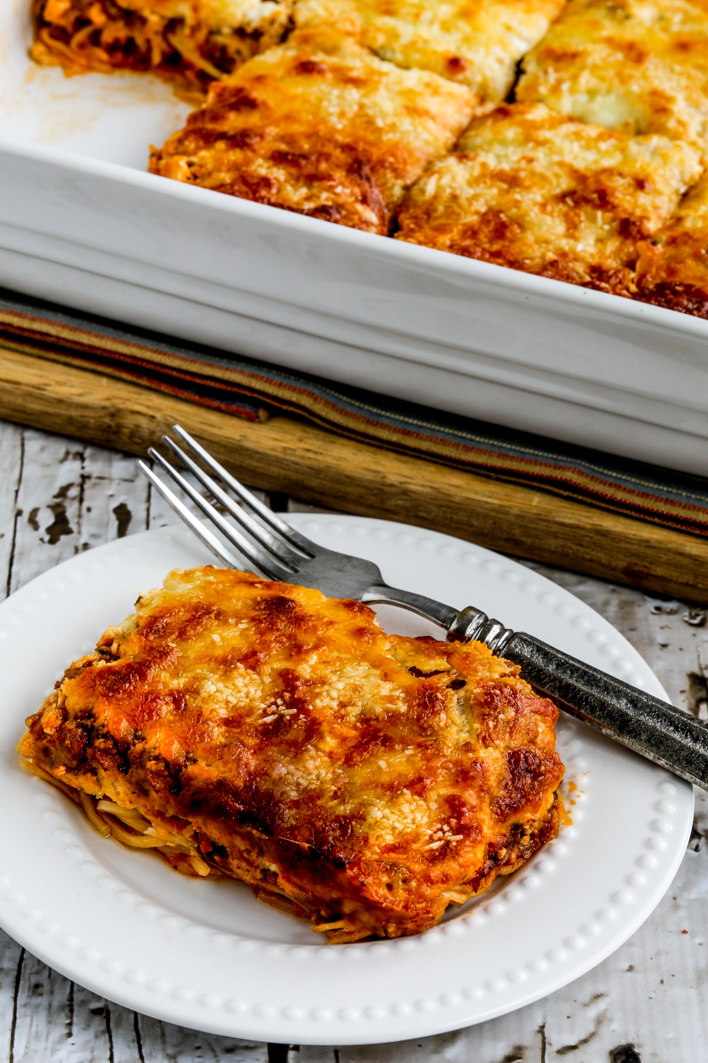 Spaghetti Casserole on plate and baking dish in background