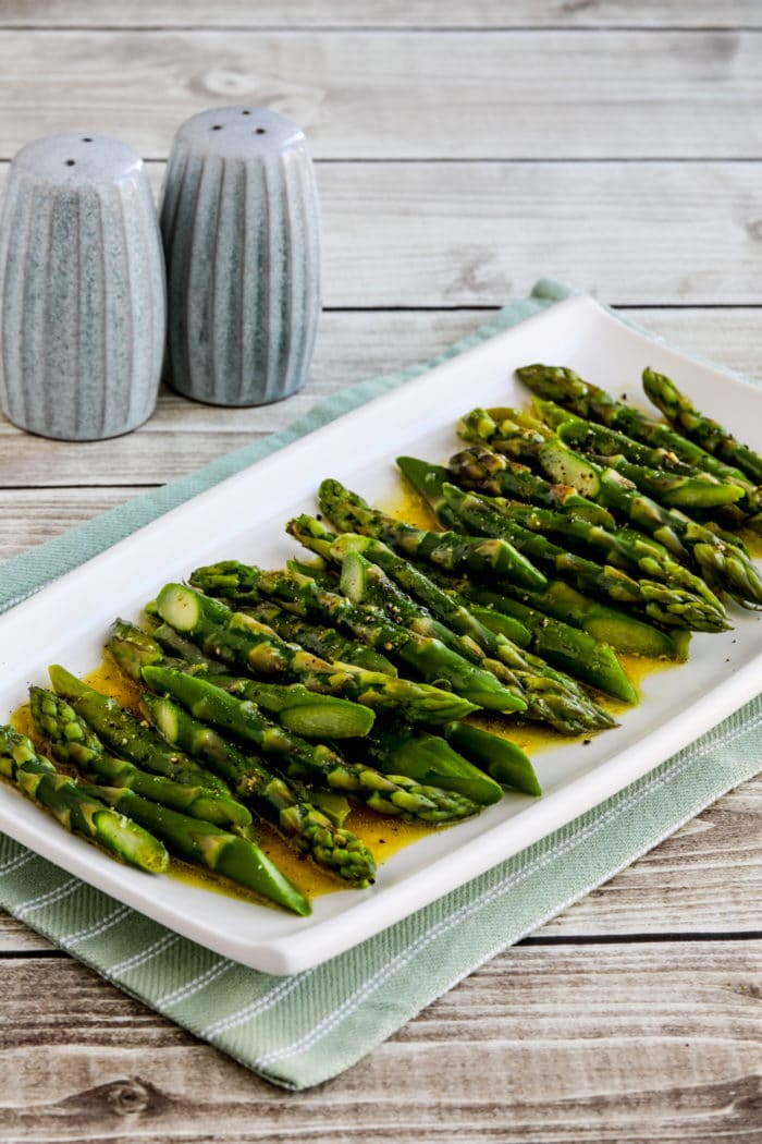 finished asparagus with vinaigrette on serving dish