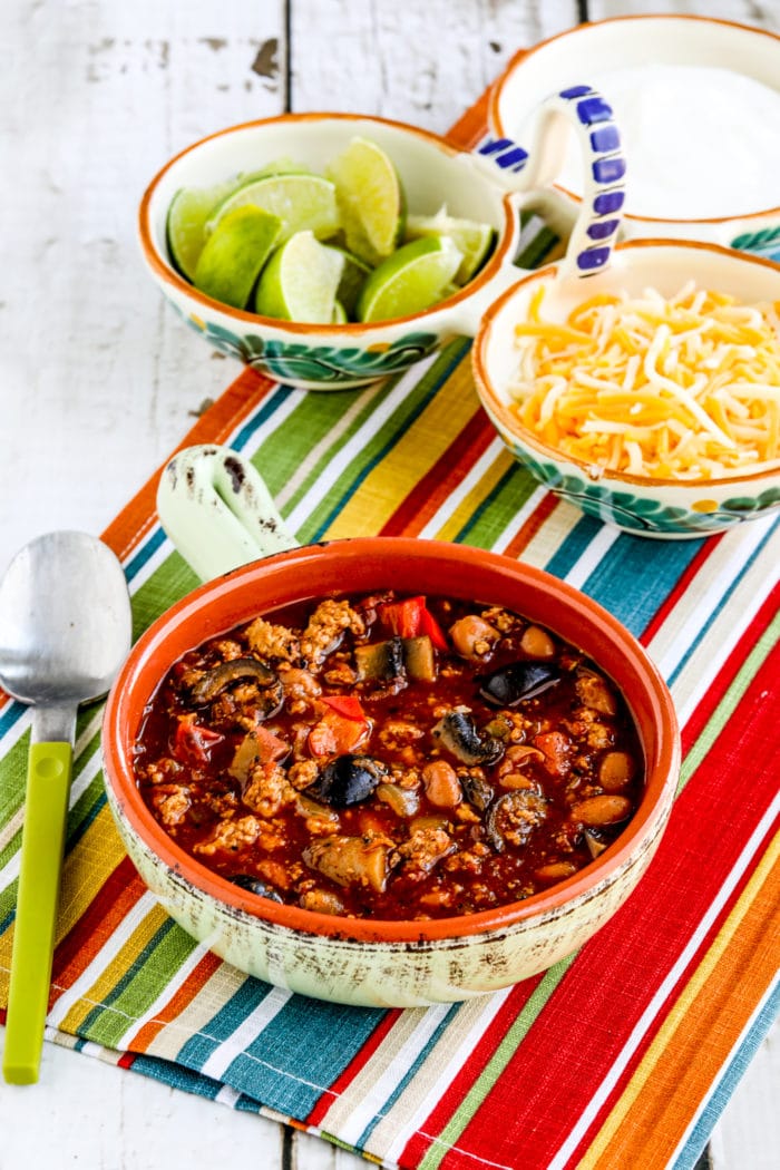 Turkey Chili with Peppers, Mushrooms, and Olives finished chili in bowl with toppings