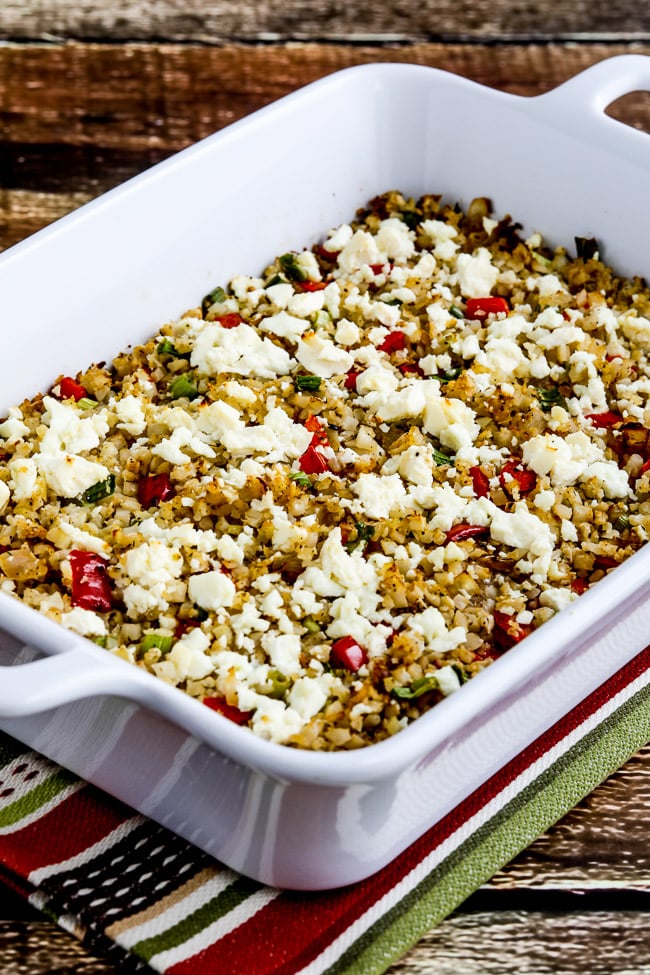 Greek Cauliflower Rice Bake shown in baking dish with crumbled Feta.