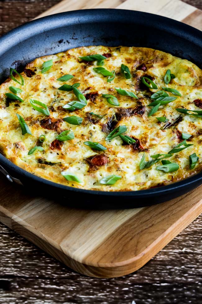 Asparagus and Tomato Frittata with Havarti and Dill shown in pan on cutting board