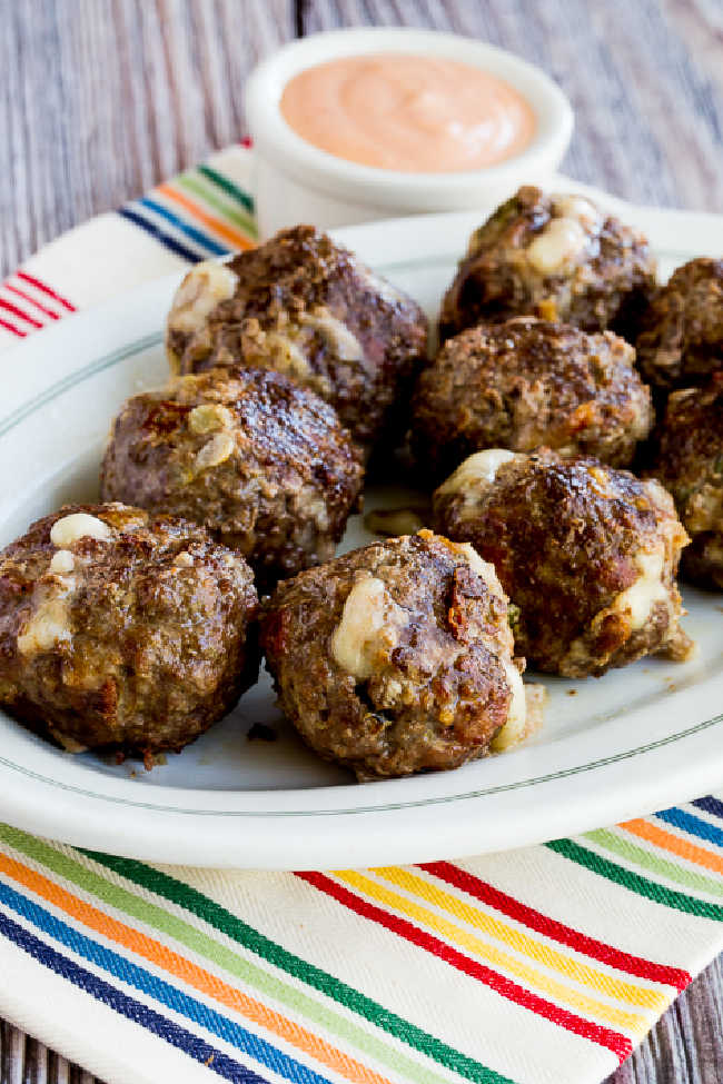 bacon cheeseburger meatballs on serving plate with fry sauce in the background