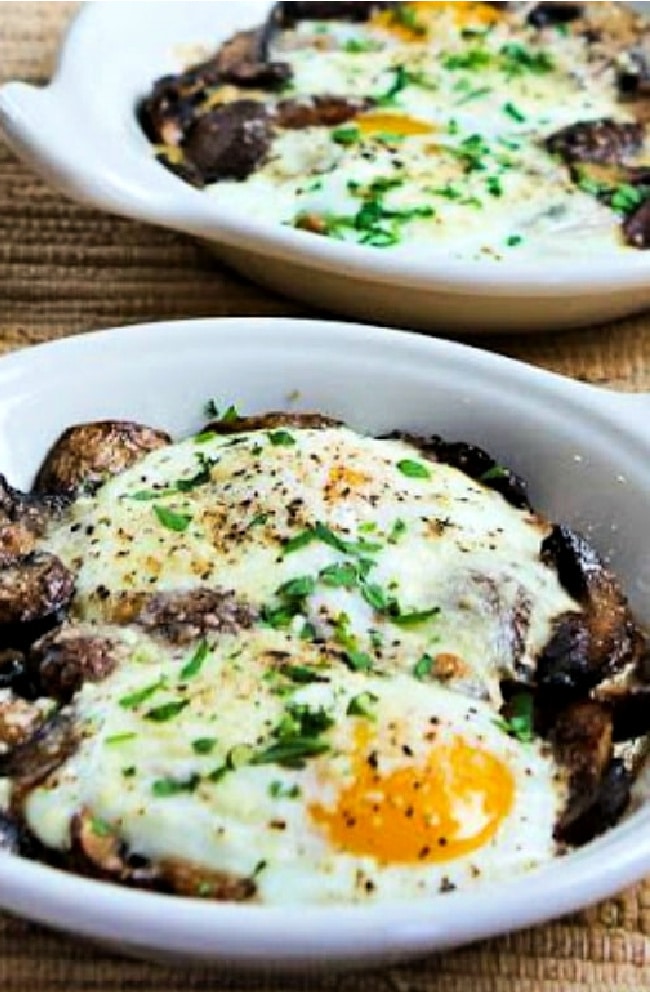 Baked Eggs with Mushrooms and Parmesan shown in two gratin dishes.