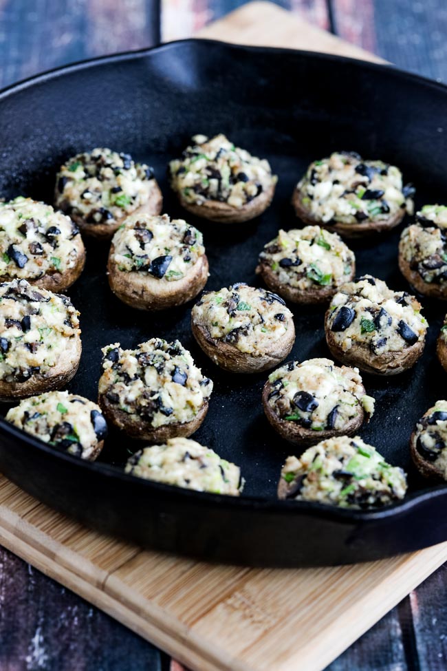 Stuffed Mushrooms with Olives and Feta finished mush rooms in cast iron pan