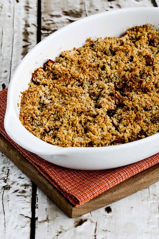 Low-Sugar Flourless Vegan Apple Crisp in baking dish on cutting board