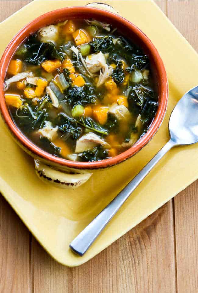 Slow Cooker Turkey Soup with Kale and Sweet Potatoes shown in bowl with spoon