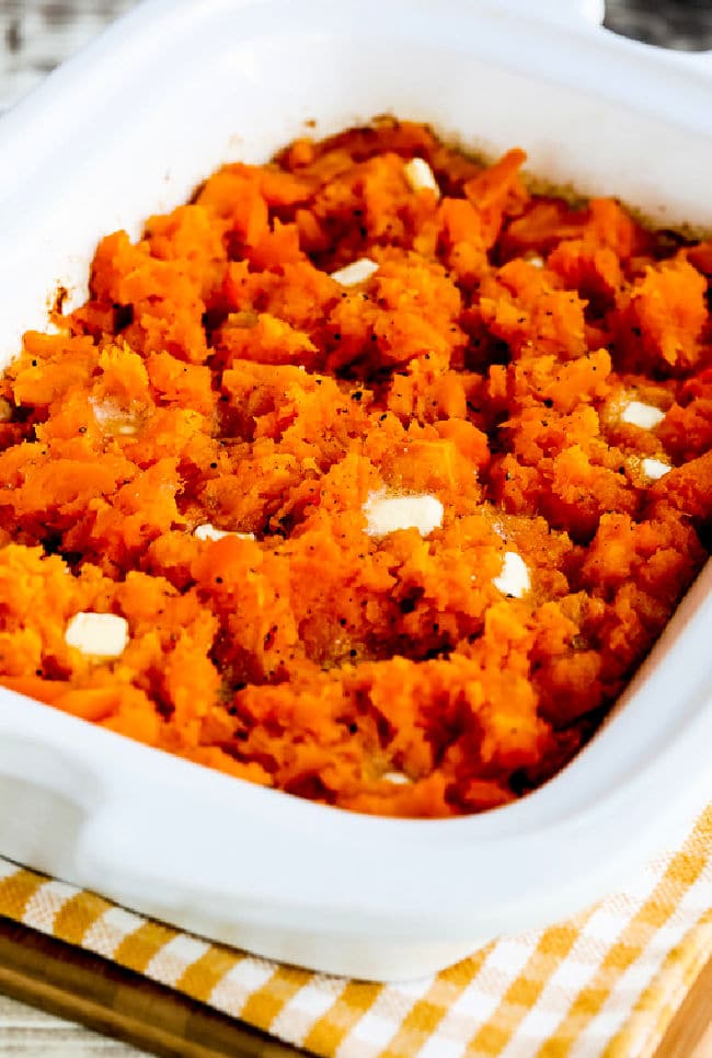 Slow Cooker Butternut Squash shown in slow cooker, dotted with butter.