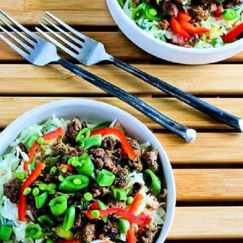 Sriracha Beef Cabbage Bowl shown in two bowls with forks.