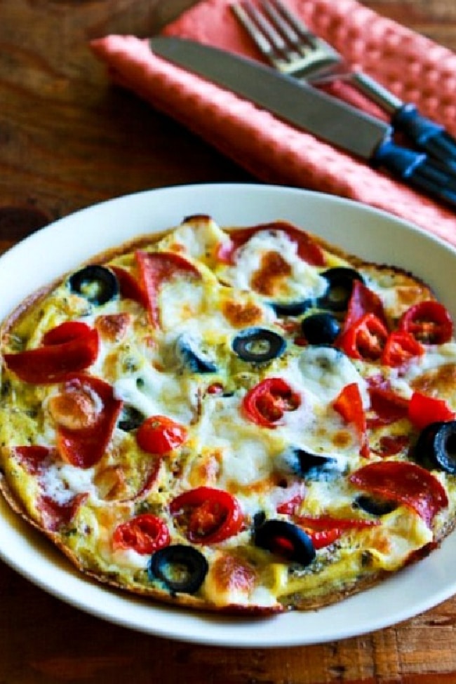 close shot of Egg-Crust Breakfast Pizza on plate with silverware