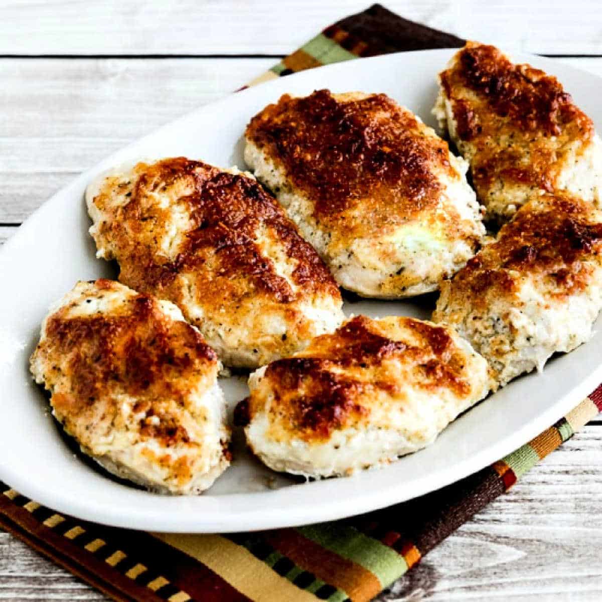 Square image of Baked Mayo Parmesan Chicken shown on serving plate.