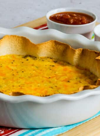 Square image for Egg and Cheese Tortilla Bake in pie plate with sour cream and salsa on the side.