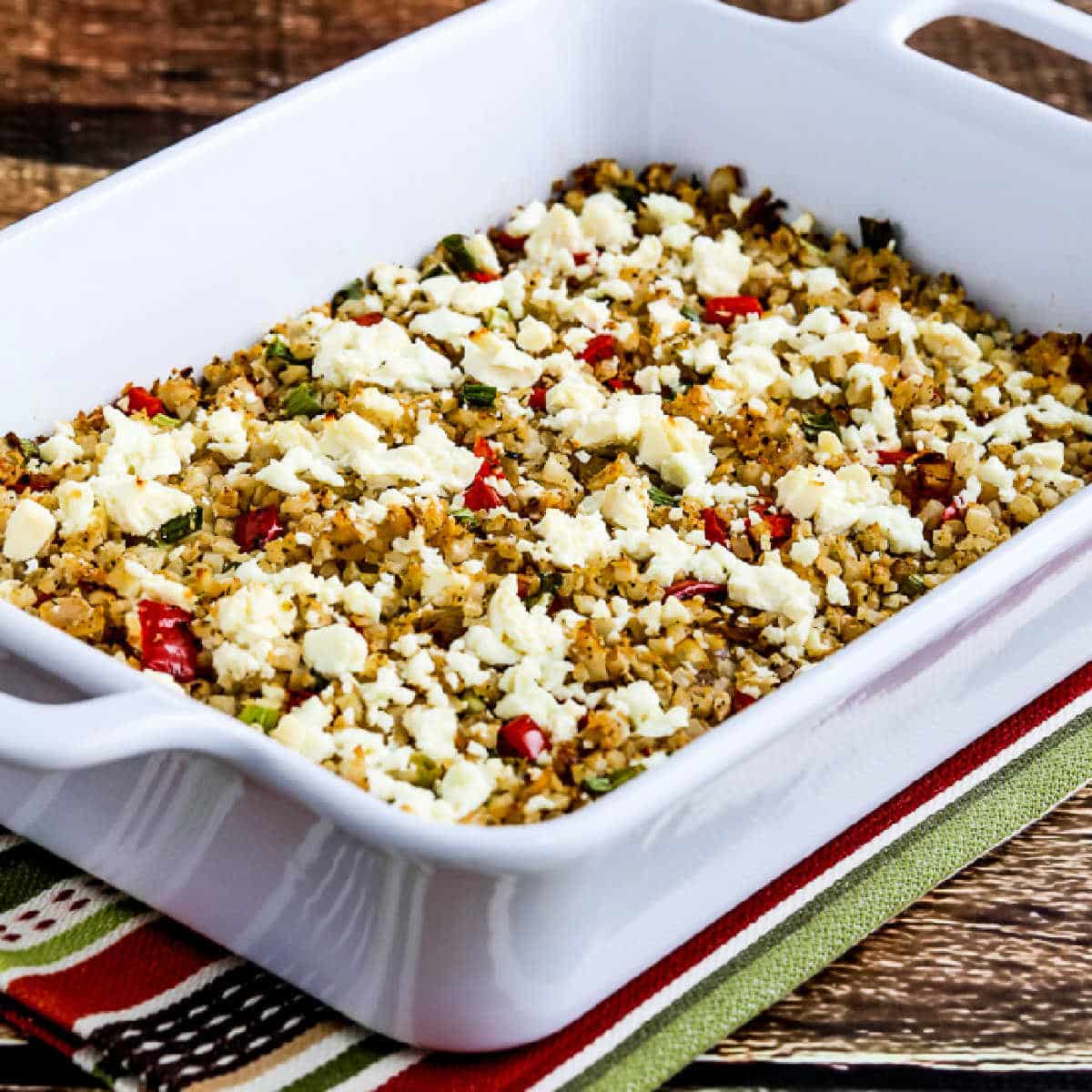 Square image of Greek Cauliflower Rice Bake shown in baking dish.