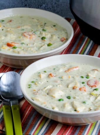 Square image for Instant Pot Chicken Pot Pie Soup in two serving bowls with Instant Pot in back.