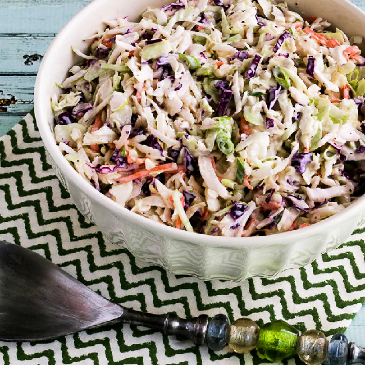 Square image of Kalyn's Keto Coleslaw Recipe in bowl with serving spoon.