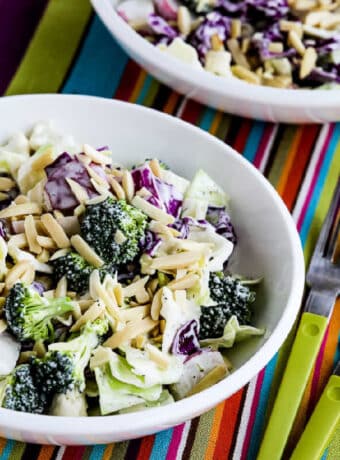 Keto Chopped Salad shown in two bowls with forks.