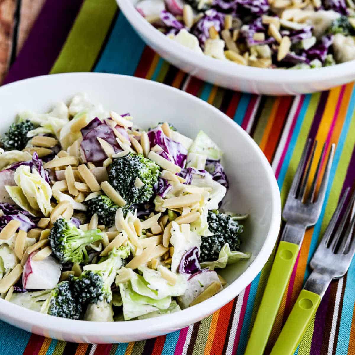 Keto Chopped Salad shown in two bowls with forks.