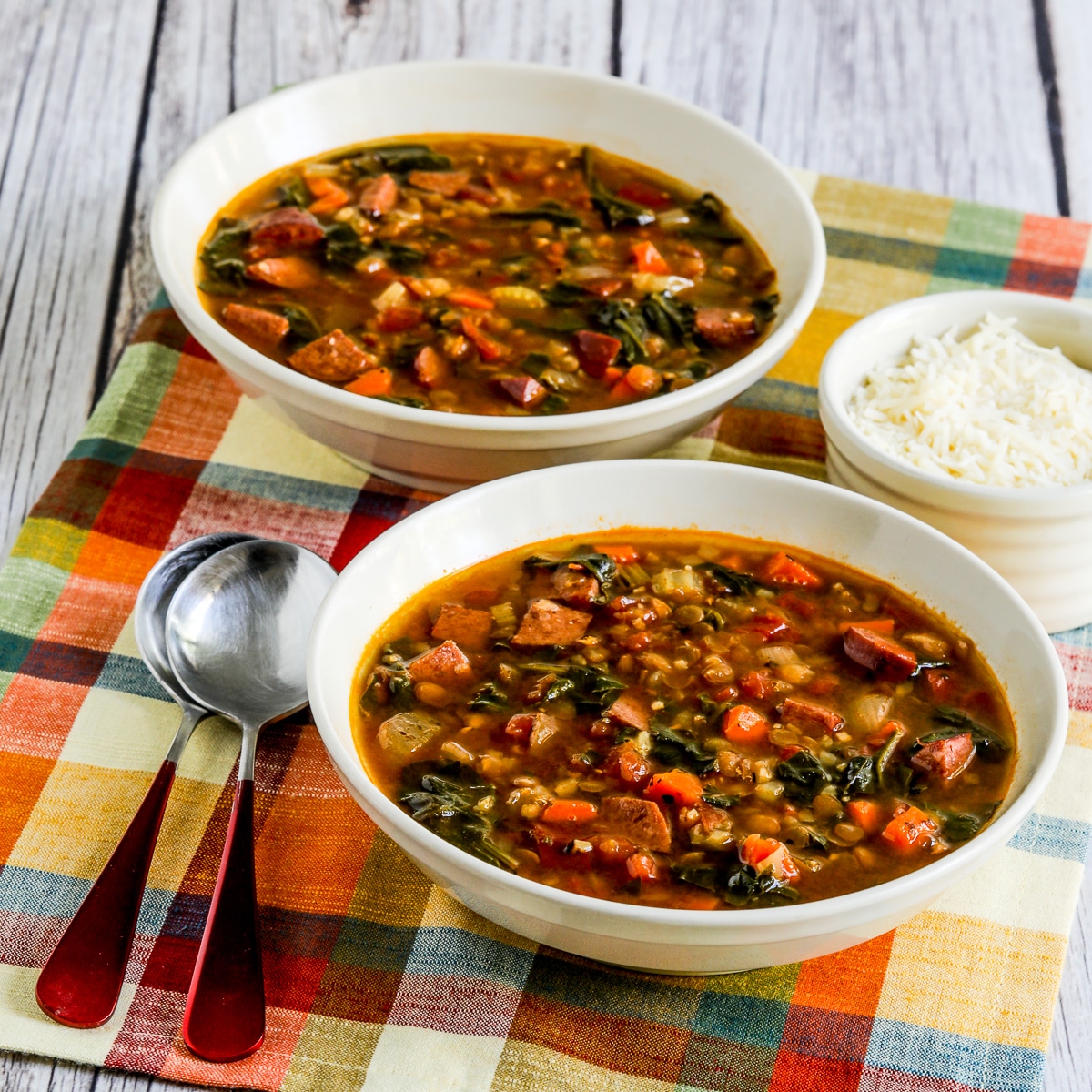 Square image of Sausage and Lentil Soup with Spinach in serving bowls.