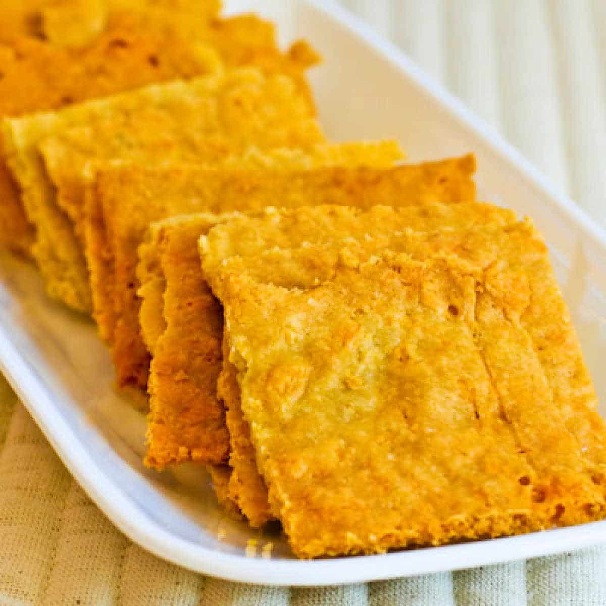 Square image for Almond Flour Cheese Crackers, shown on plate.