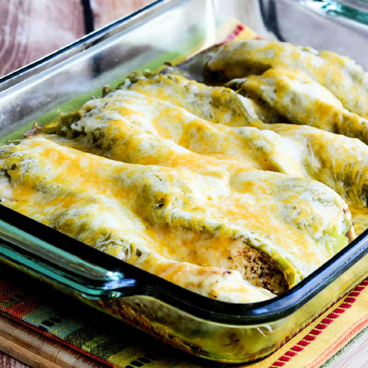 Chicken with Green Chiles and Cheese shown in baking dish with melted cheese