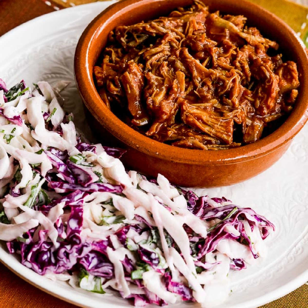 Low-Carb Slow Cooker Pulled Pork shown on plate with coleslaw