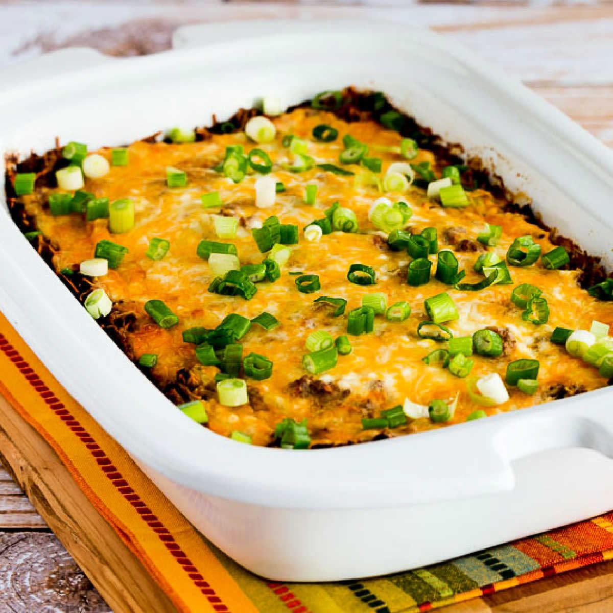 Square image of Slow Cooker Mexican Lasagna Casserole shown in Casserole Crock Pot.