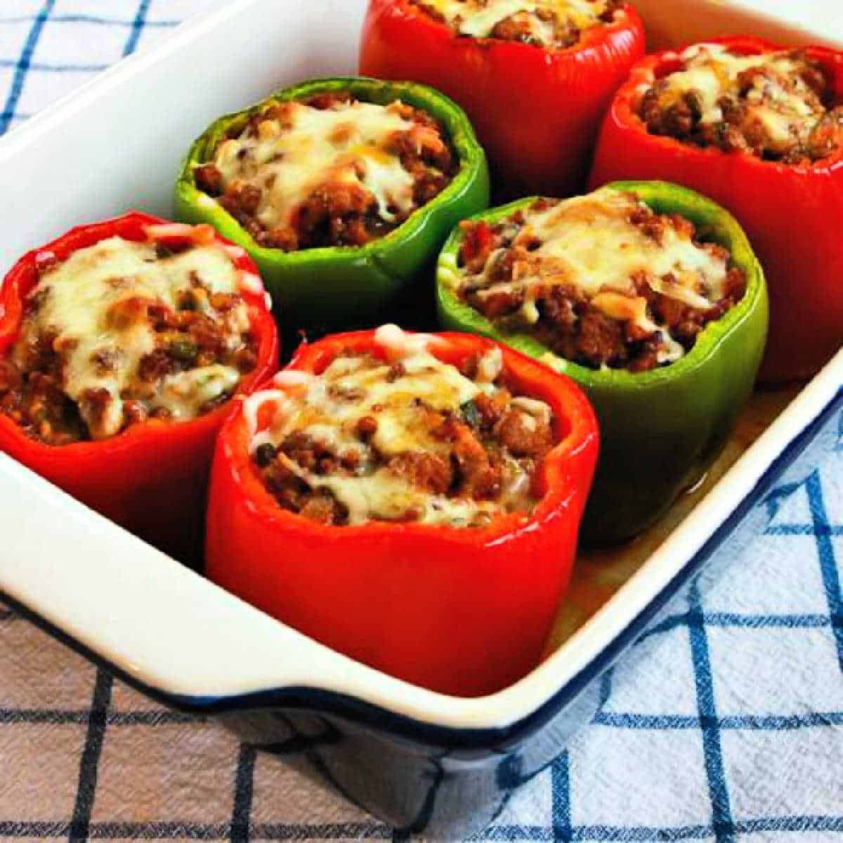 Large square image of Stuffed Peppers with Italian Sausage and Ground Beef shown in baking dish.