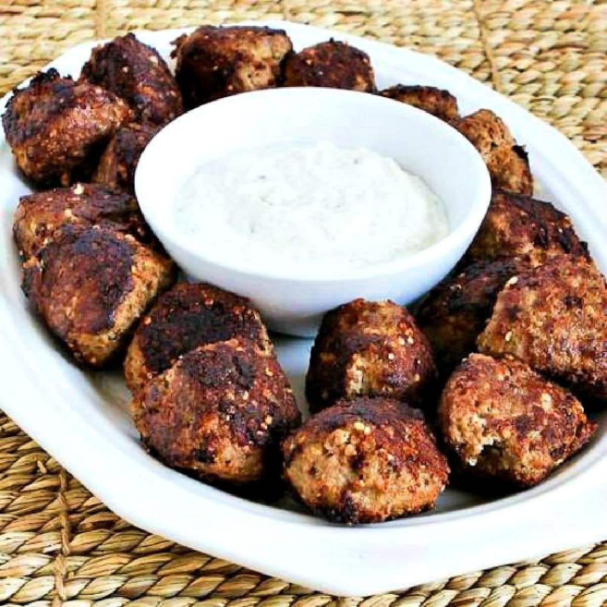 Turkey Parmesan Meatballs shown on serving platter with Tzatziki Sauce.