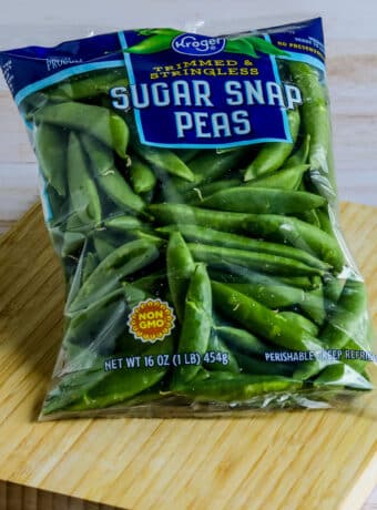 Square image for Sugar Snap Peas in bag shown on cutting board.