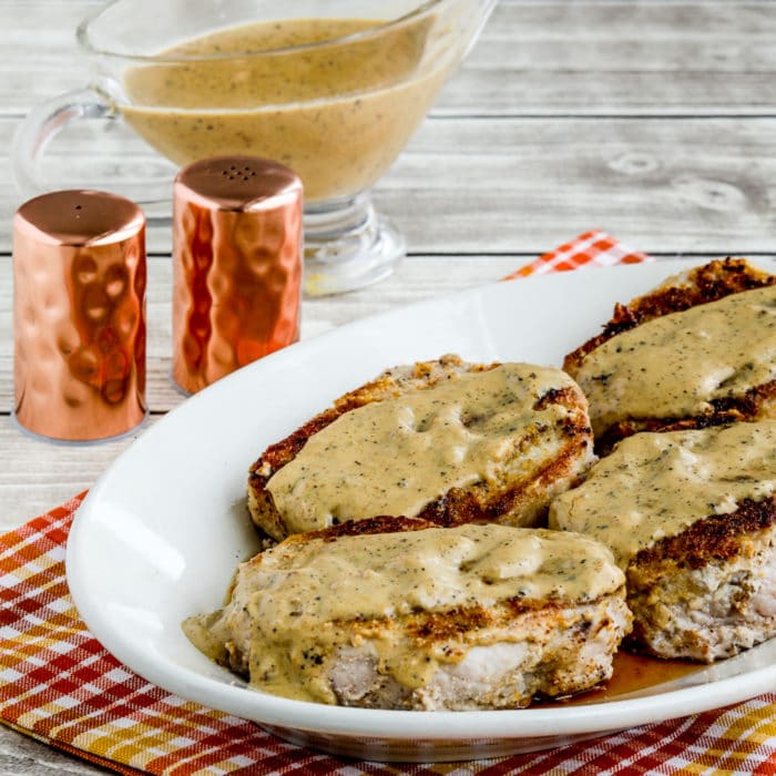 Square image of Grain-Free Breaded Pork Chops on serving platter with gravy