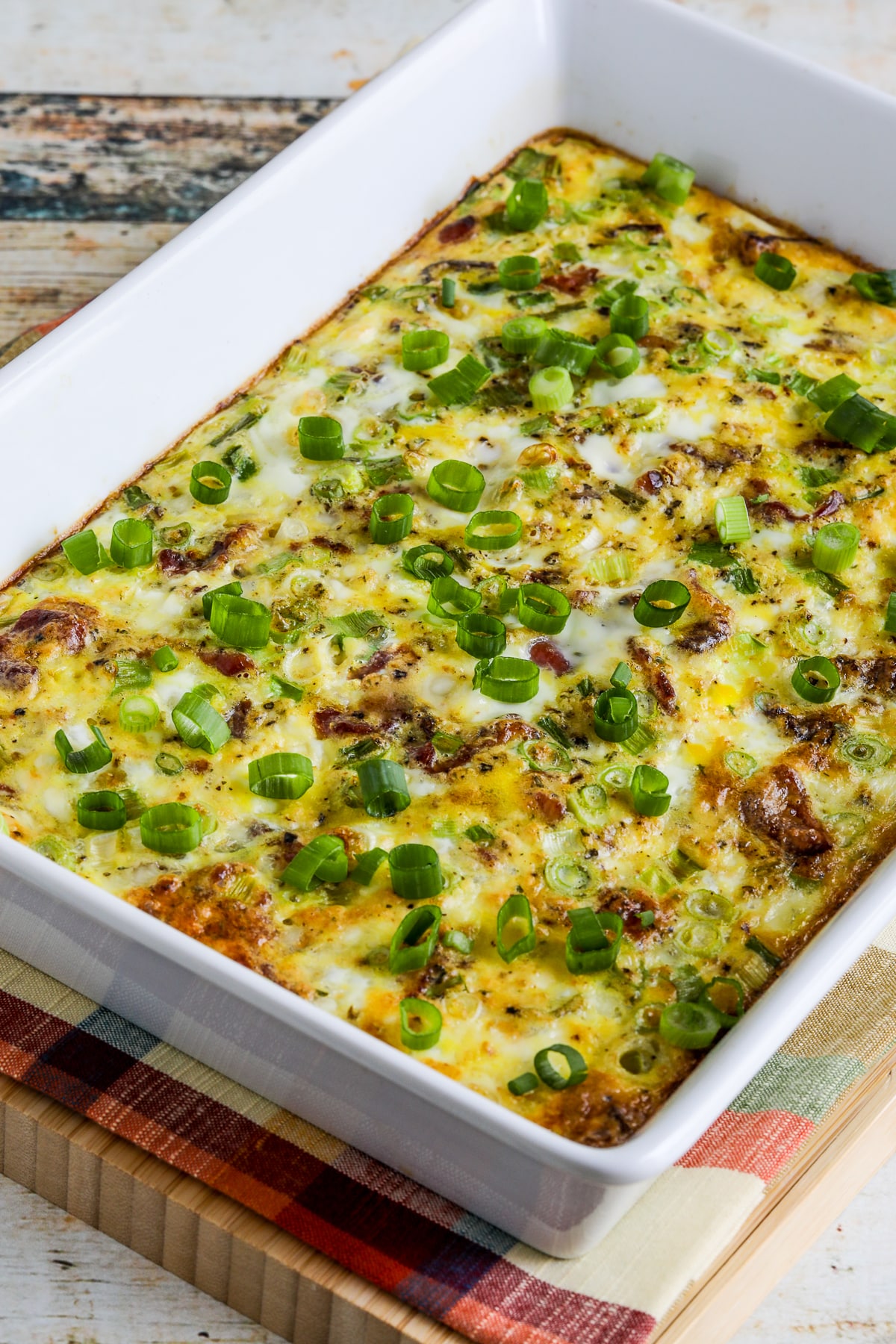 Bacon Feta Breakfast Casserole in baking dish on napkin.