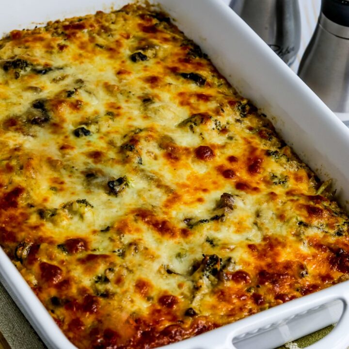 Cheesy Vegetarian Casserole (with Cauliflower Rice) shown in baking dish with salt and pepper in back.