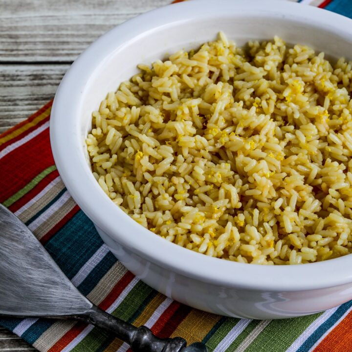 Close photo of Greek Lemon Rice shown in bowl with serving spoon.