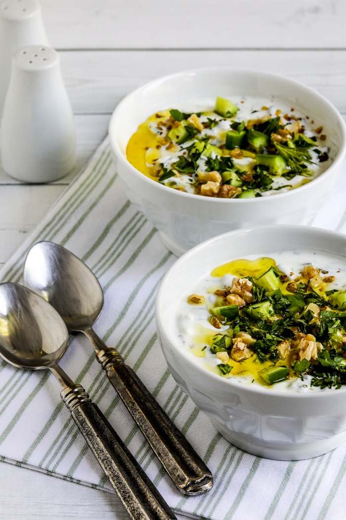 Tarator (Chilled Cucumber Yogurt Soup) shown in two bowls with spoons and napkin.