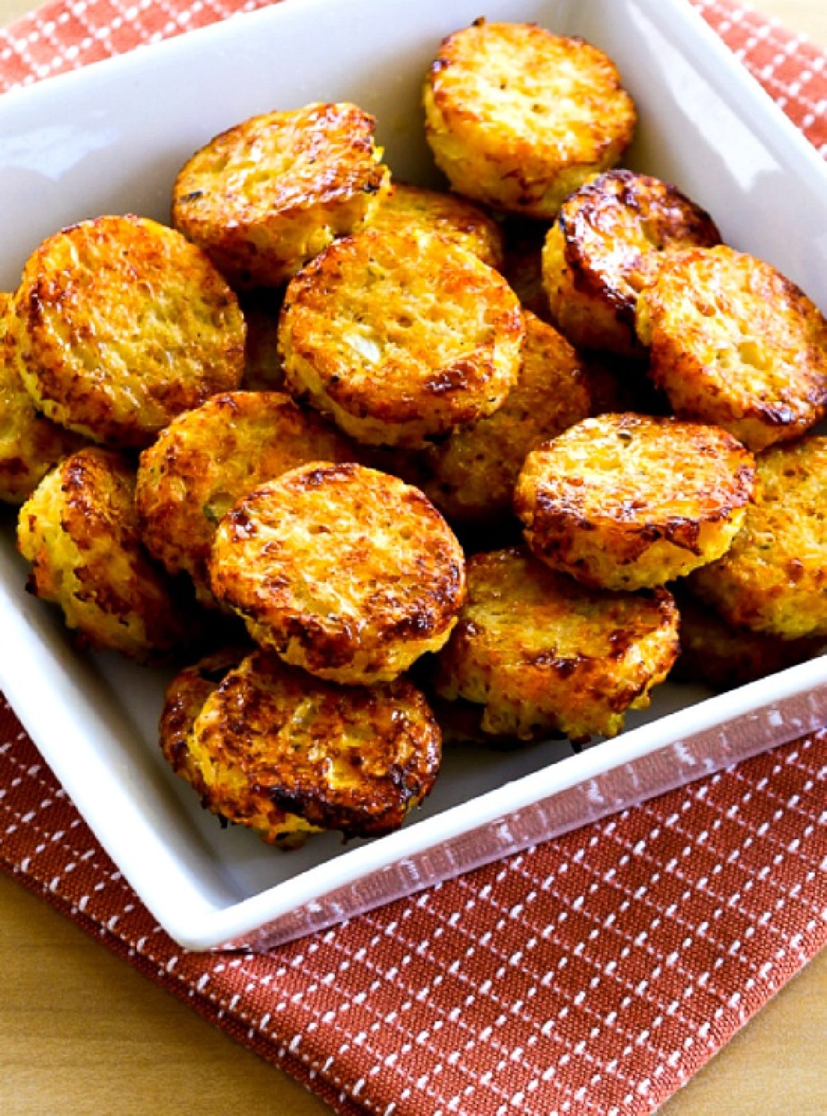 Cheesy Baked Cauliflower Tots in serving bowl on napkin