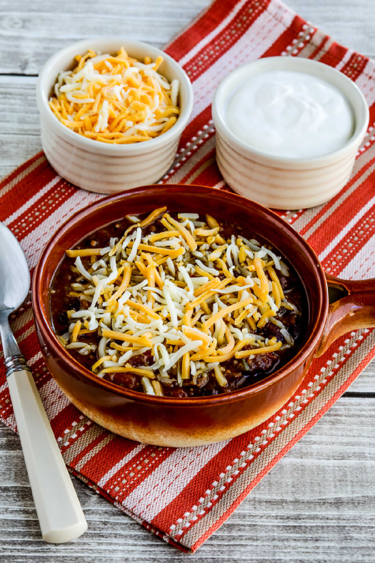 Pumpkin Chili with Ground Beef in serving bowl with cheese