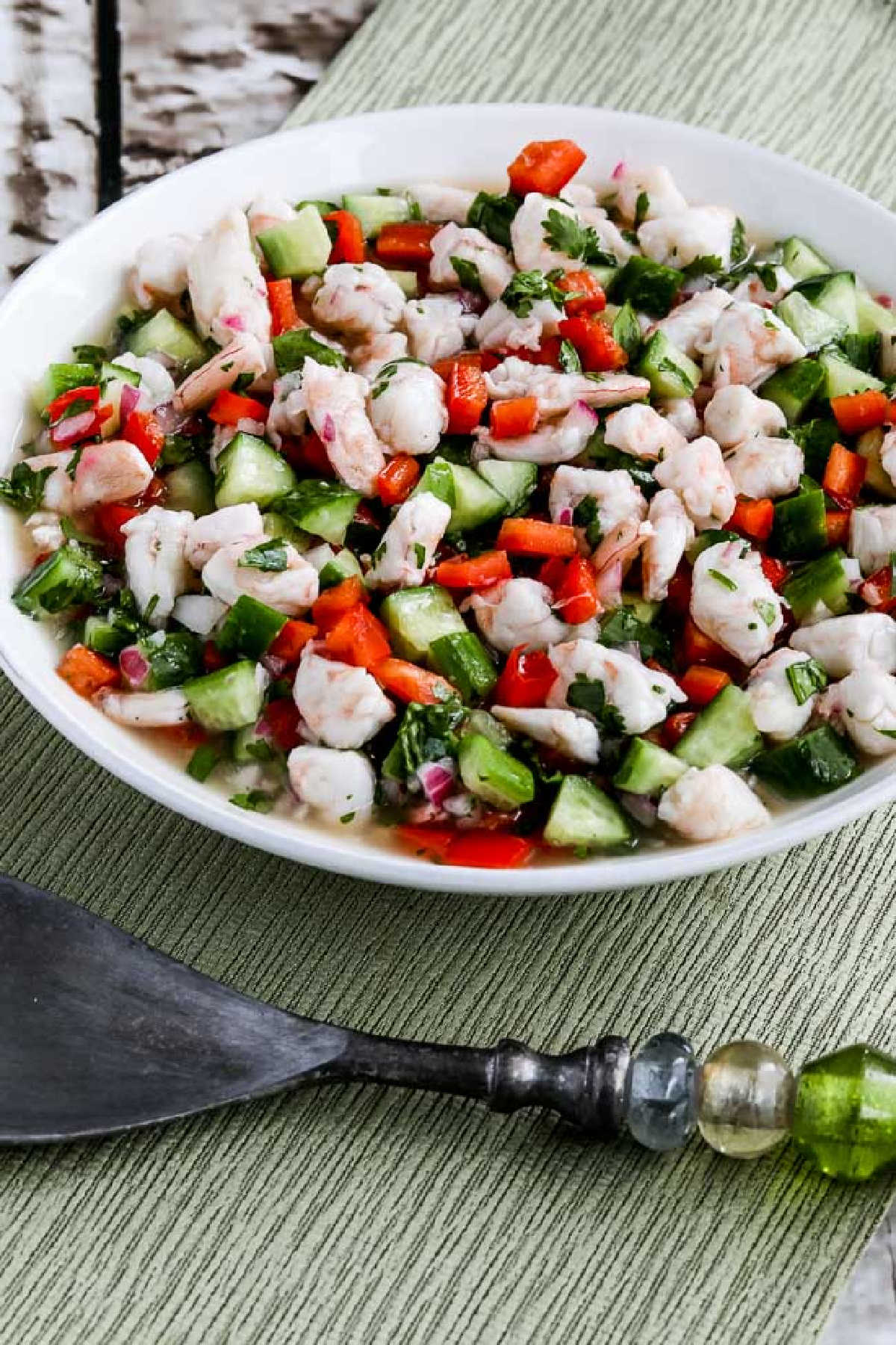 Easy Shrimp Ceviche Recipe shown in serving dish on green napkin with fork