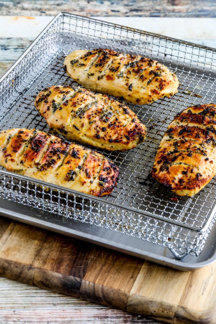 Air Fryer Marinated Chicken Breasts shown in basket, farther away