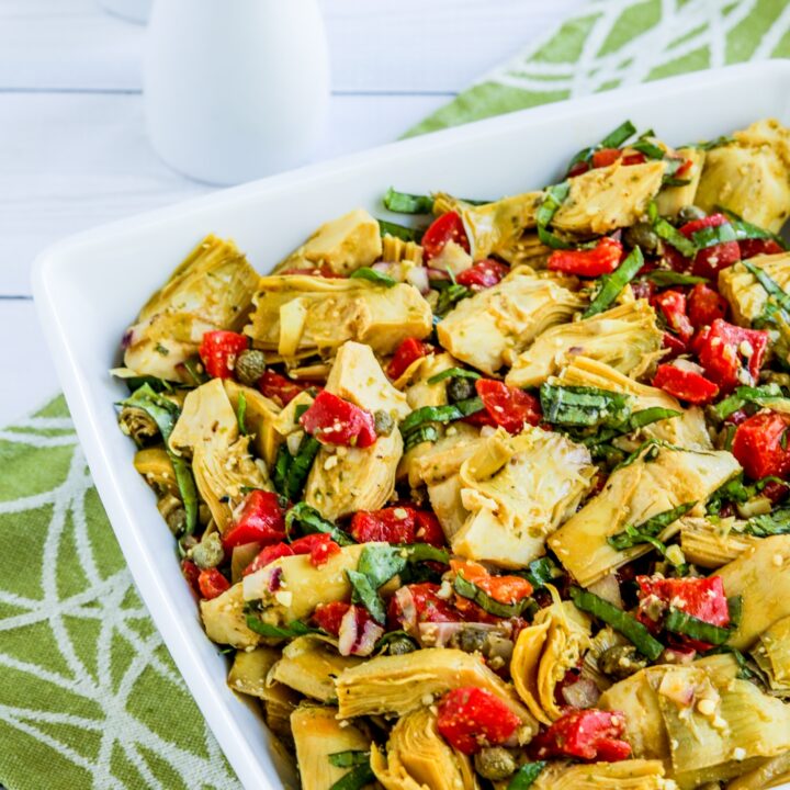 Artichoke Heart Salad shown in serving bowl with napkin and salt-pepper