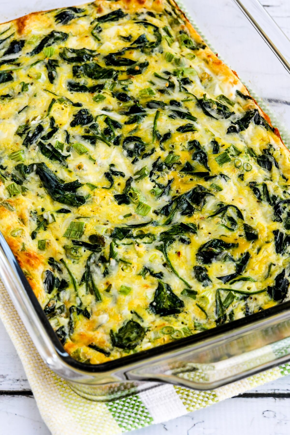 Spinach and Mozzarella Egg Bake shown in baking sheet on napkin