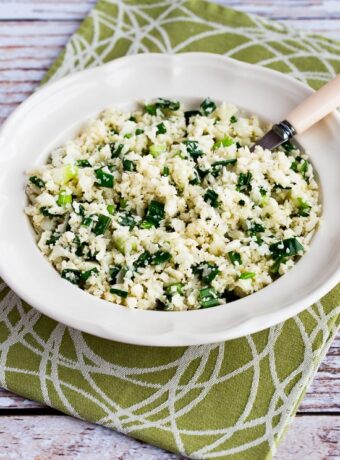 Easy Cauliflower Rice with Garlic and Green Onion shown in serving bowl with spoon