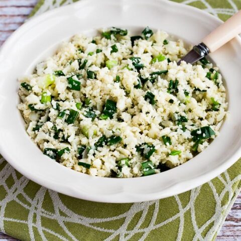 Easy Cauliflower Rice with Garlic and Green Onion shown in serving bowl with spoon