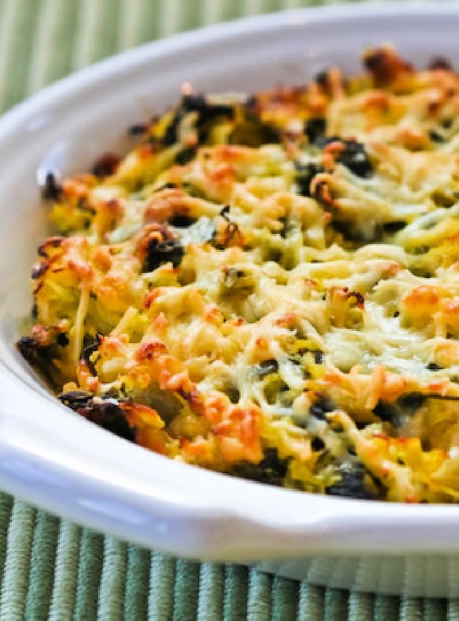 Spaghetti Squash Gratin with Chard shown in baking dish on green placemat.