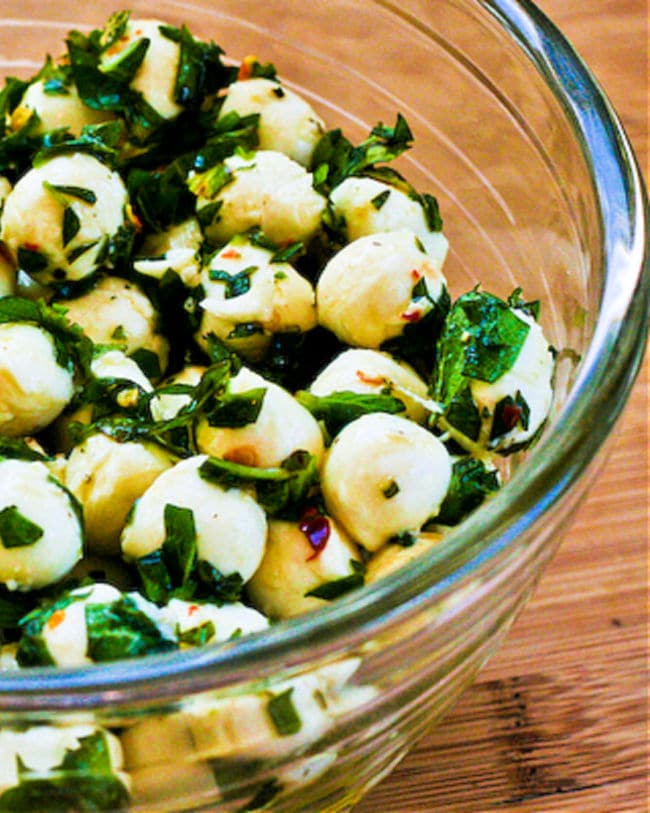 Marinated Mozzarella balls with fresh herbs.